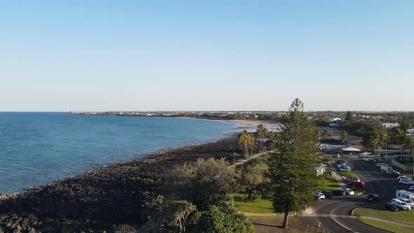 A high revealing drone video showing the coastline and open areas of the small town of Bargara locat