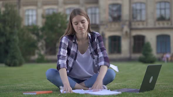 Angry and Tired Young Woman Crumpling Paper and Throwing Paper Notebooks