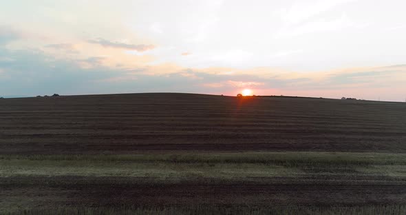 Agriculture Aerial View of Harvested Wheat Field at Sunset alt
