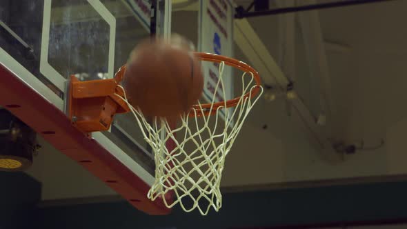 basketballs are shot at hoop during practice from a low angle closeup