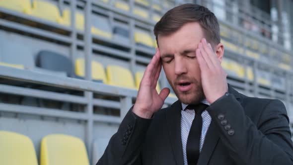 A Tired Office Worker is Standing in the Middle of the Street He Has a Headache