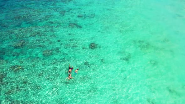 Aerial tourism of marine lagoon beach time by blue sea with white sandy background of a picnic near 