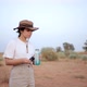 Woman drinking water in desert field - VideoHive Item for Sale
