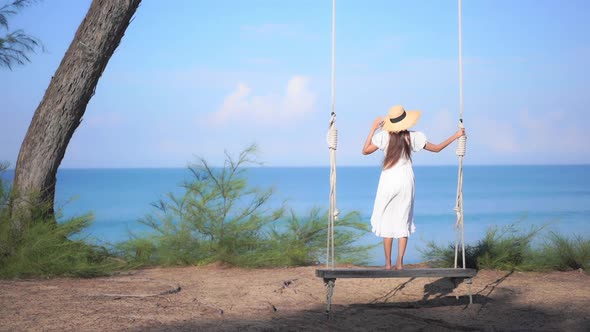 Asian woman enjoy around beautiful beach sea ocean