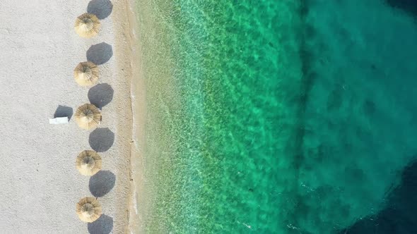 Aerial view on the seashore with umbrella. Vacation and adventure.