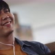 Happy young Asian man listening for music with headphone in living room. - VideoHive Item for Sale