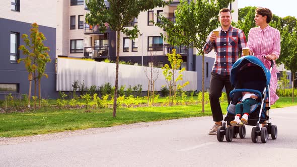 Family with Baby in Stroller and Coffee in City