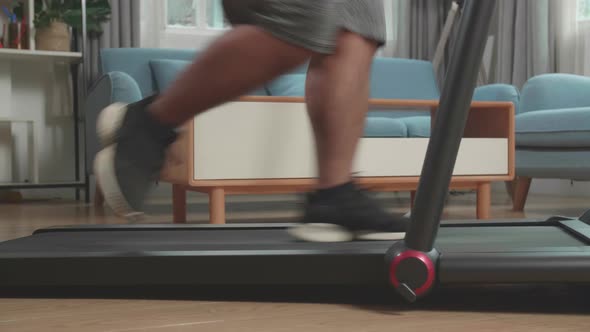 Legs Of Asian Fat Man Running On A Treadmill At Home At Home