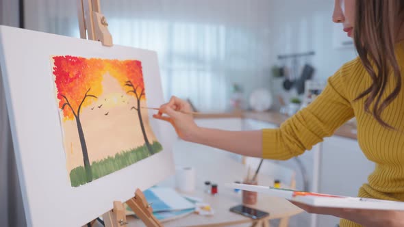 Asian young talented woman draw art picture, creating artwork with watercolor paint and brush.