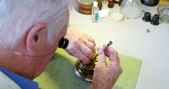 Horologist repairing a watch