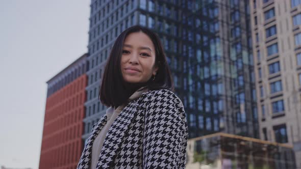 Lowangle Portrait of a Young Adult Asian Woman in Downtown District