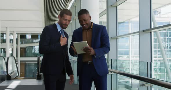 Young businessmen using tablet in a modern office