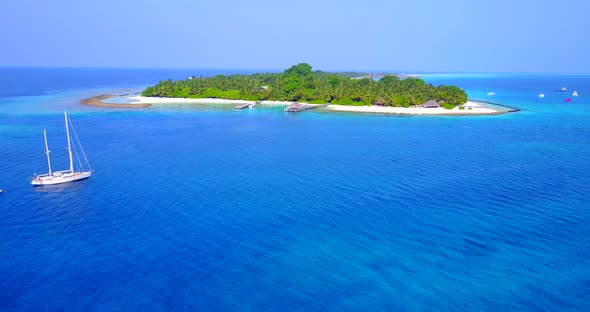 Tropical aerial island view of a summer white paradise sand beach and blue water background in 4K