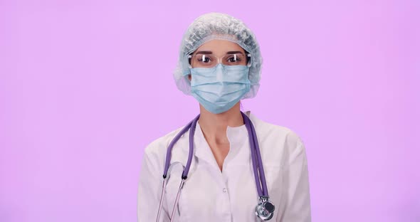 Portrait of Young Female Doctor in Protective Gear and Medical Mask Woman Looks at the Camera