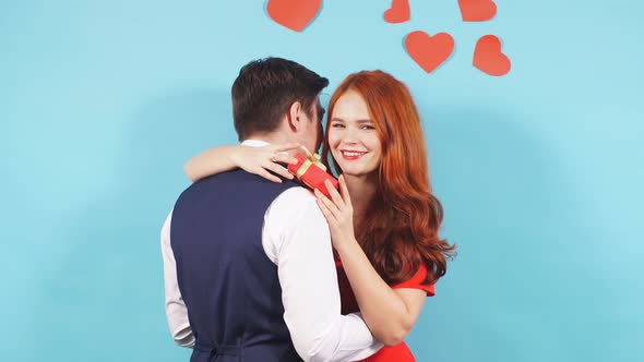 Gallant Man Hugging Girlfriend After Giving a Gift