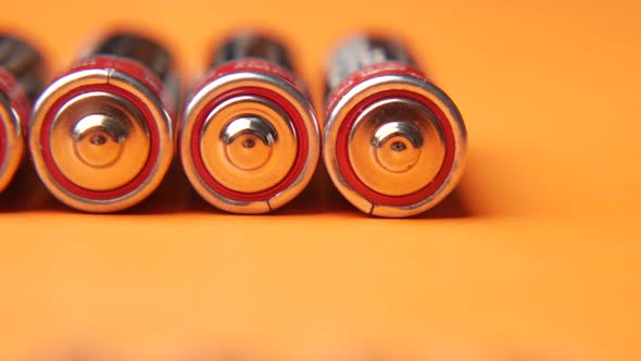 Close Up of Batteries on Orange Background