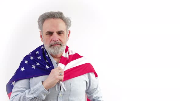 Aged Caucasian Man Shows Peace Sign While Having USA Flag on His Shoulders Medium Closeup White