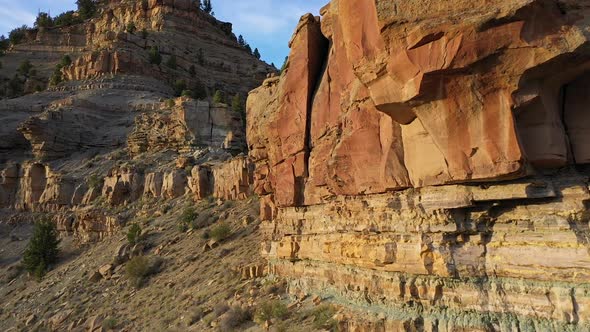 Flying along red rock cliffs in the Utah desert rising along the ridge