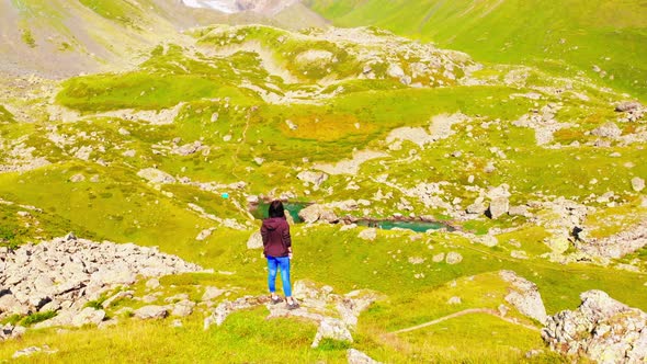 Female Person Stand Surrounded By Green Mountains Nature