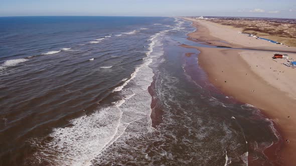 Aerial View Along Sea Waves Along Katwijk aan Zee Beach Coastline In South Holland On Bright Clear D