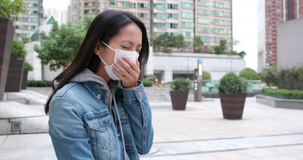 Woman coughing with wearing face mask at outdoor