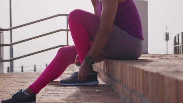 Caucasian woman preparing for a run in a park