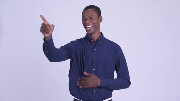 Young Happy African Businessman Laughing and Pointing Finger