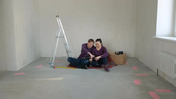 Young Couple Drinking Champagne in New Home