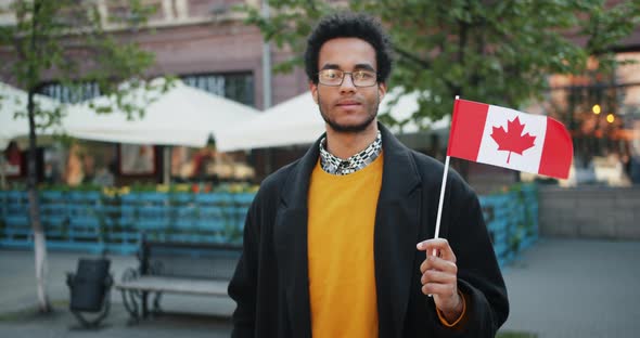 Slow Motion Portrait of Bearded African American Man Outdoors with Canadian Flag