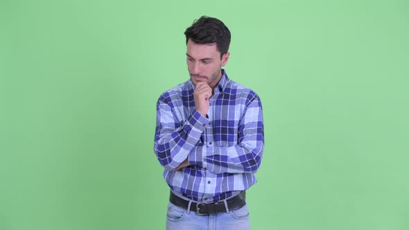 Stressed Young Hispanic Man Thinking and Looking Down