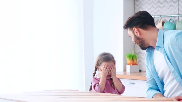 Father giving a birthday present to his daughter