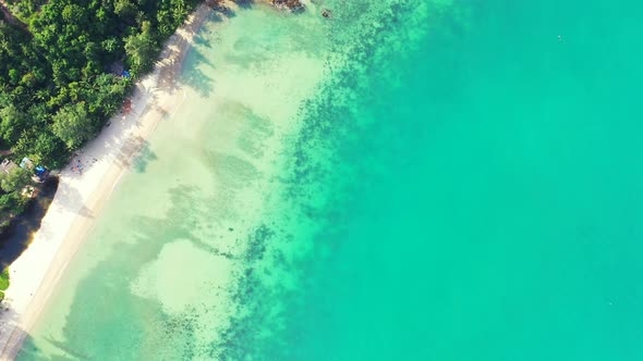 Natural drone clean view of a white sandy paradise beach and aqua blue ocean background 