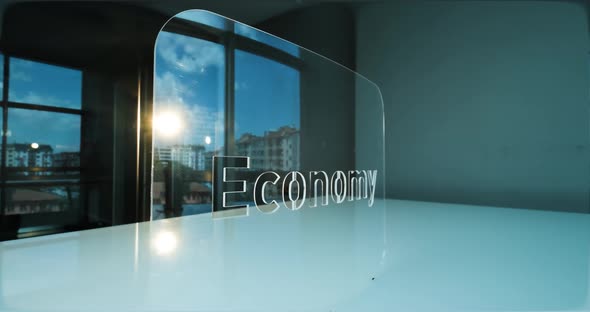 Glass Economy Letters and Office in Background
