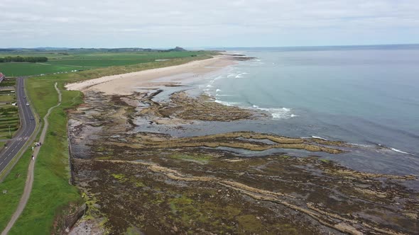 Aerial footage of the seaside coastal town of the village of Seahouses, a large village in the UK