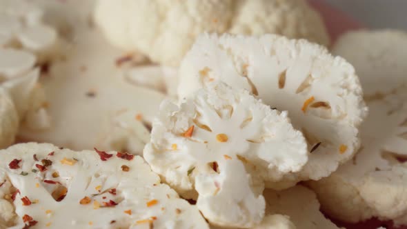 Raw Slices of Cauliflower Sprinkled with Spices