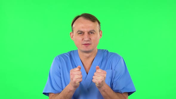 Medical Man Looking at the Camera with Excitement, Then Celebrating Victory. Green Screen