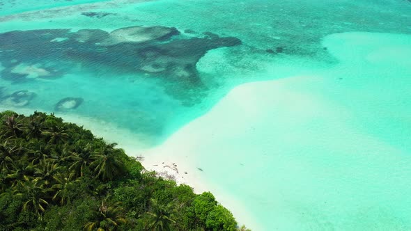 Beautiful fly over abstract shot of a white sand paradise beach and turquoise sea background in colo