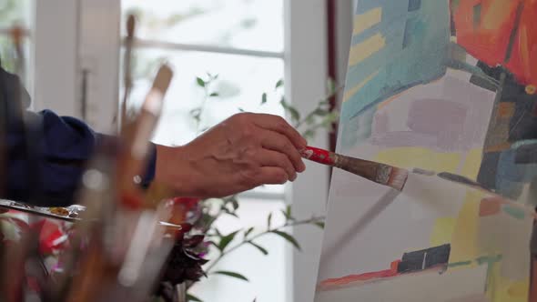 Woman Artist Applying Paint with Brush Strokes on Canvas Brush Closeup