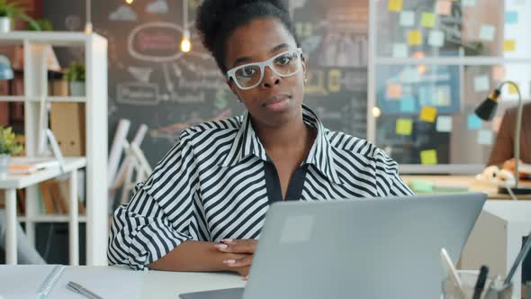 Slow Motion Portrait of Young African American Woman Sitting in Office