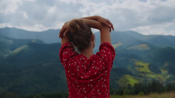 Back View Relaxed Girl Standing Slope Putting Hands on Head Cloudy Day Close Up