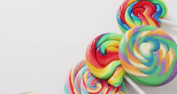 Video of rows multicoloured lollipops on white background