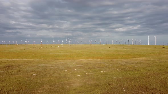 Aerial View of White Windmills in the Steppe Zone Against a Beautiful Cloudy Sky