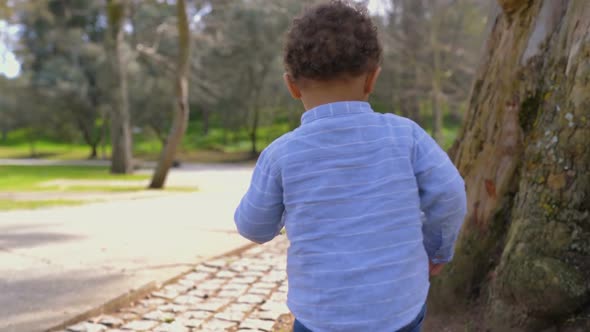 Little Boy Running Away From His Father, Turning Back, Smiling