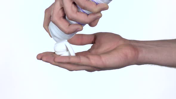 Shaving Foam Is Squeezed in Palm of Hand. Slow Motion