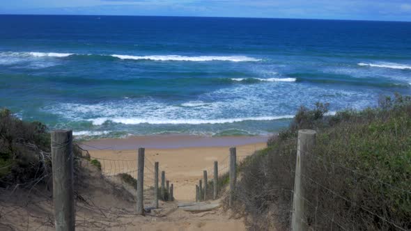 Steep decent down onto an Australian Beach. Wooden stairs.