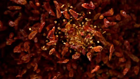 Super Slow Motion Shot of Dried Red Chili Peppers Explosion on Black Background at 1000Fps