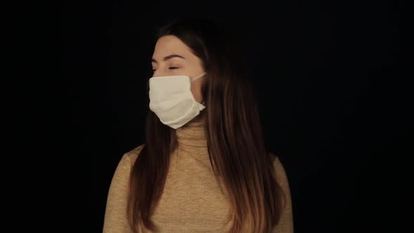 Girl Looks Around and Takes Off a Protective Mask and Look in Tha Camera. Coronavirus. COVID-19