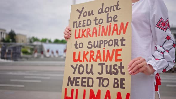 Ukrainian Woman Holds Poster Standing for Native Country
