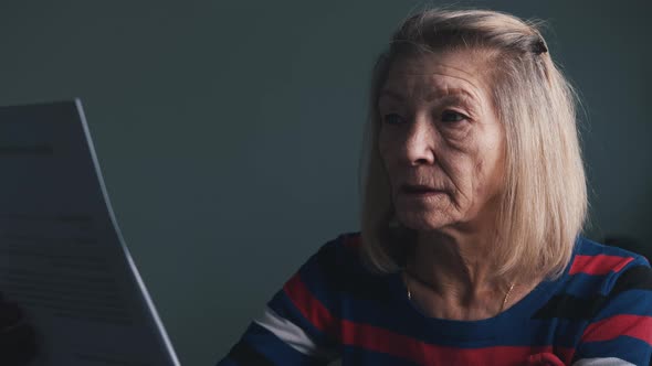 Elderly Woman Reading Doctor Report