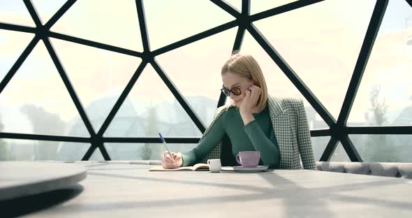 Female Freelancer Working Alone at Spacious Cafe